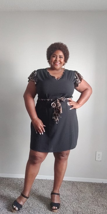 reviewer wearing the dress in gray with leopard accents
