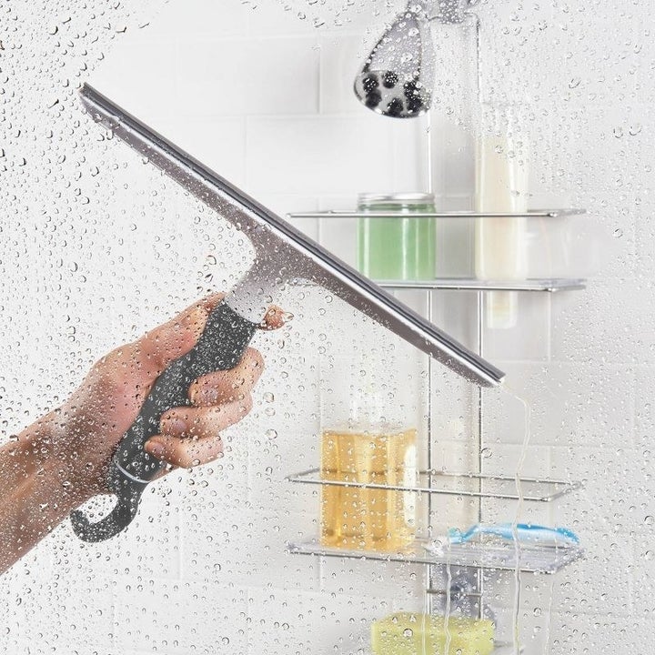 the squeegee cleaning a shower door
