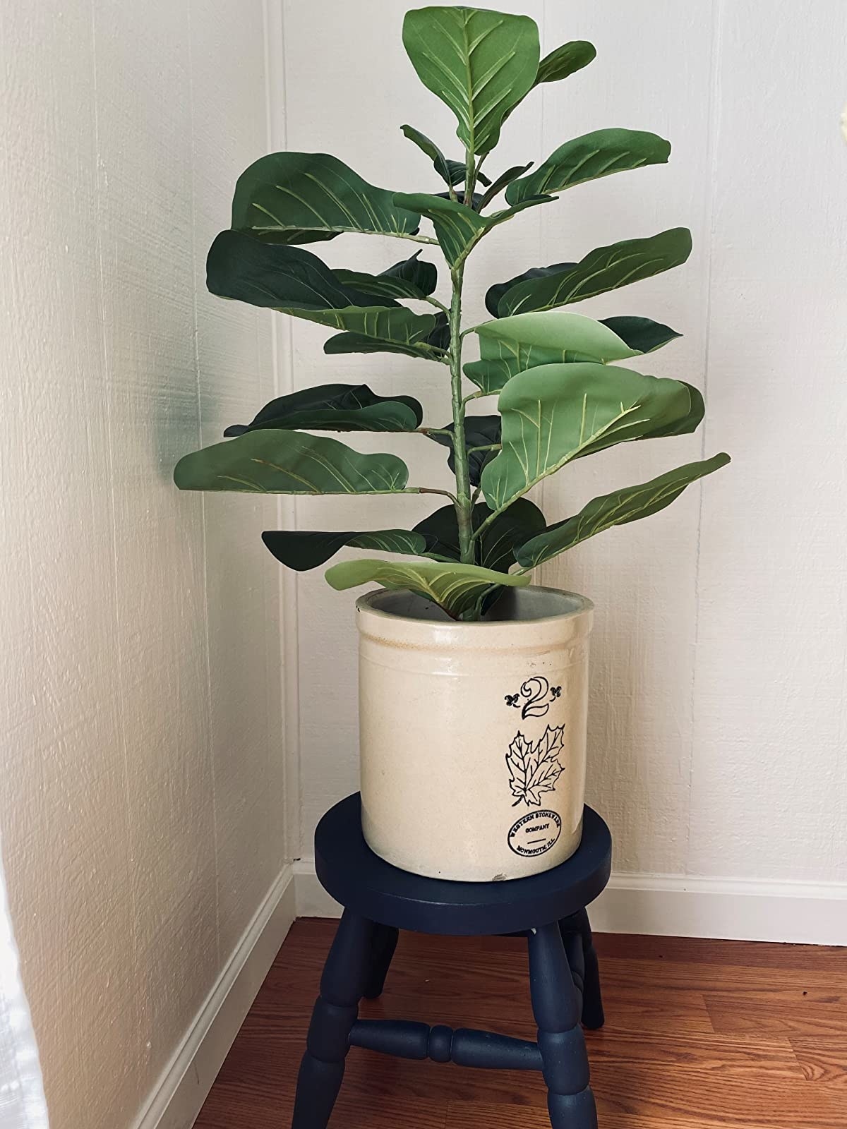 Reviewer image of faux plant in a crock on a blue stool