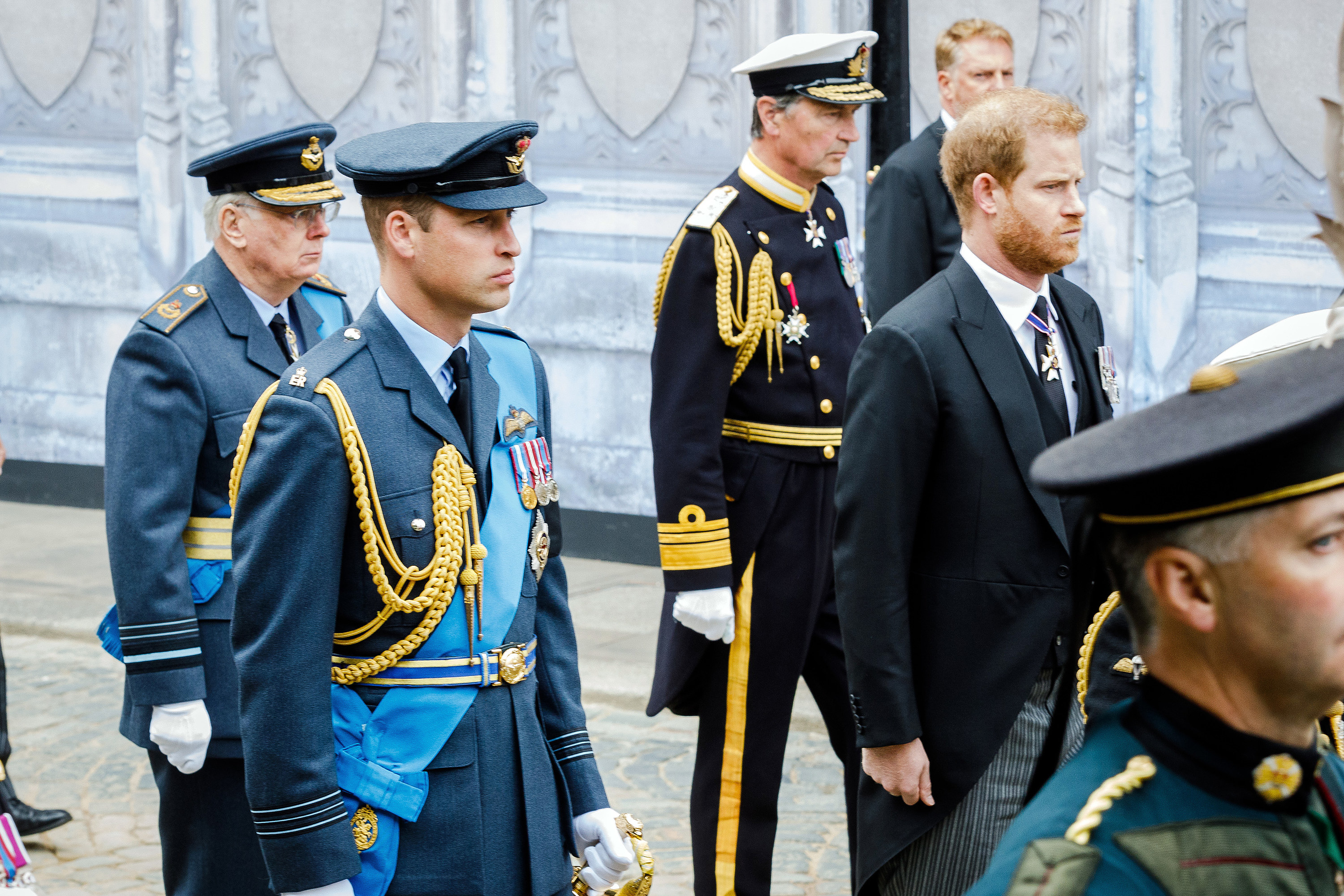 Prince Richard, Prince William, and Vice Admiral Tim Laurence in dress military and Prince Harry in a suit walk behind the Queen&#x27;s coffin at her state funeral