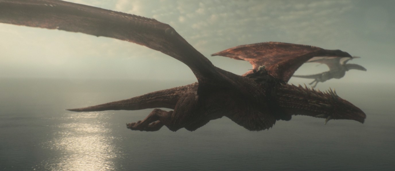 Two dragons fly above the sea