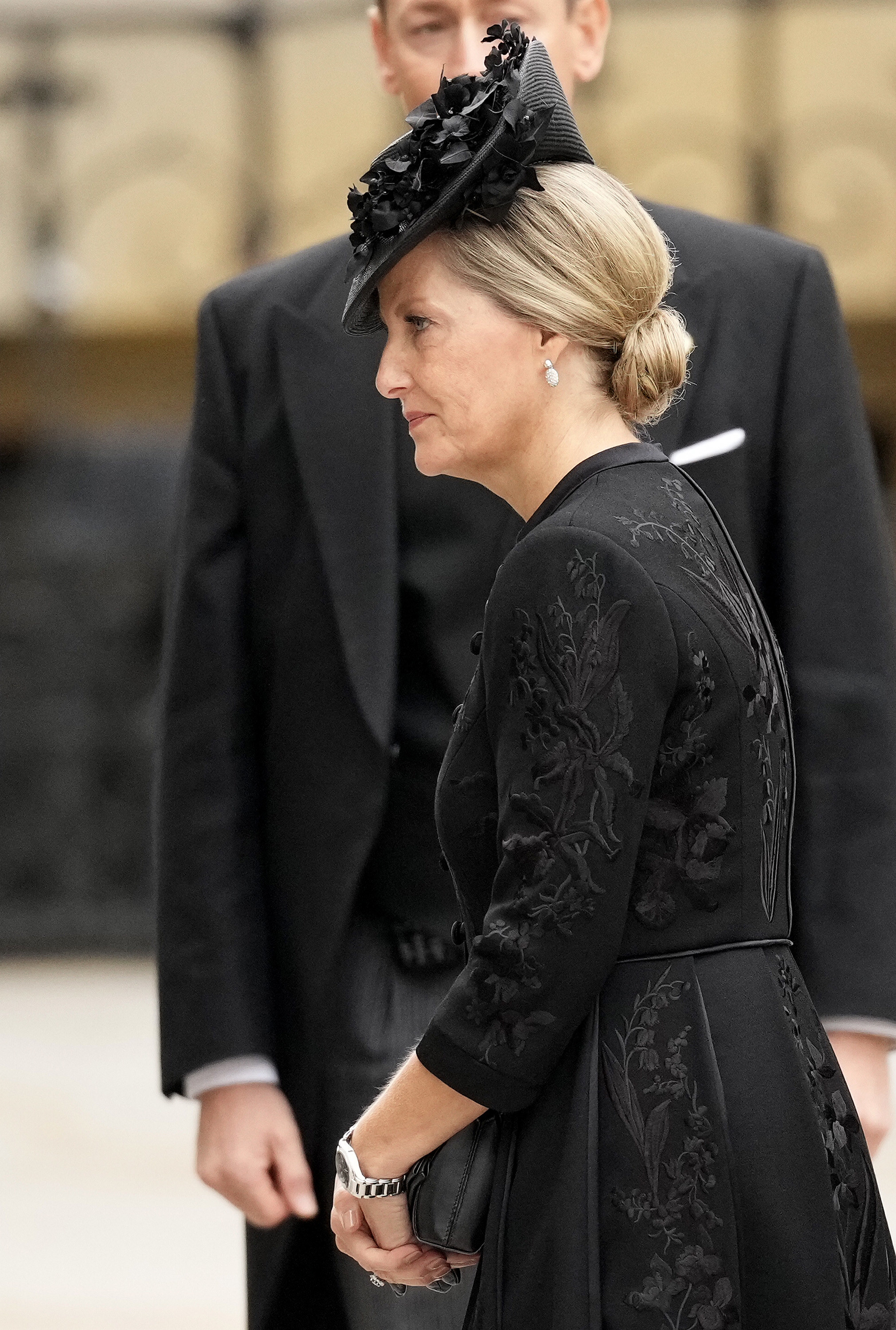 Sophie wears a black dress and hat as she arrives for the funeral