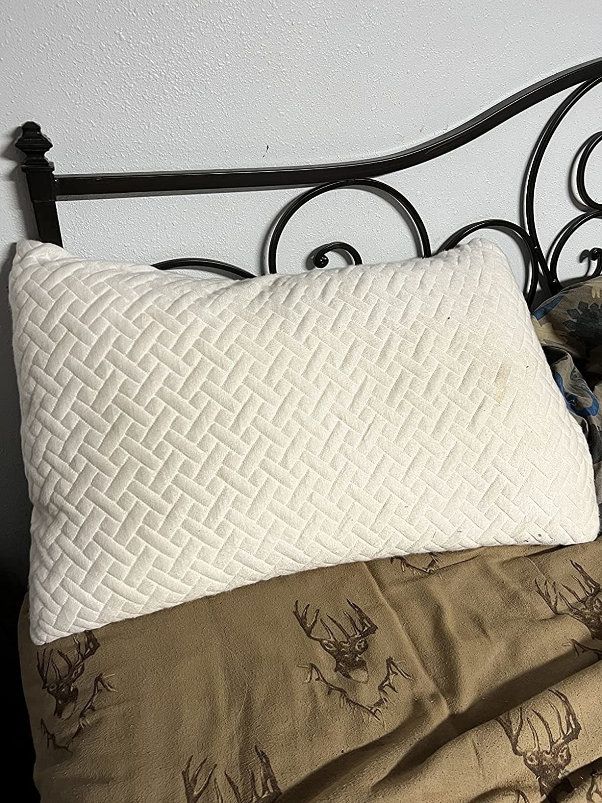 Reviewer&#x27;s photo of the pillow on bed