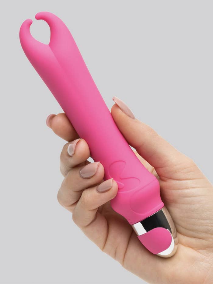 A person holding the vibrator in their hand