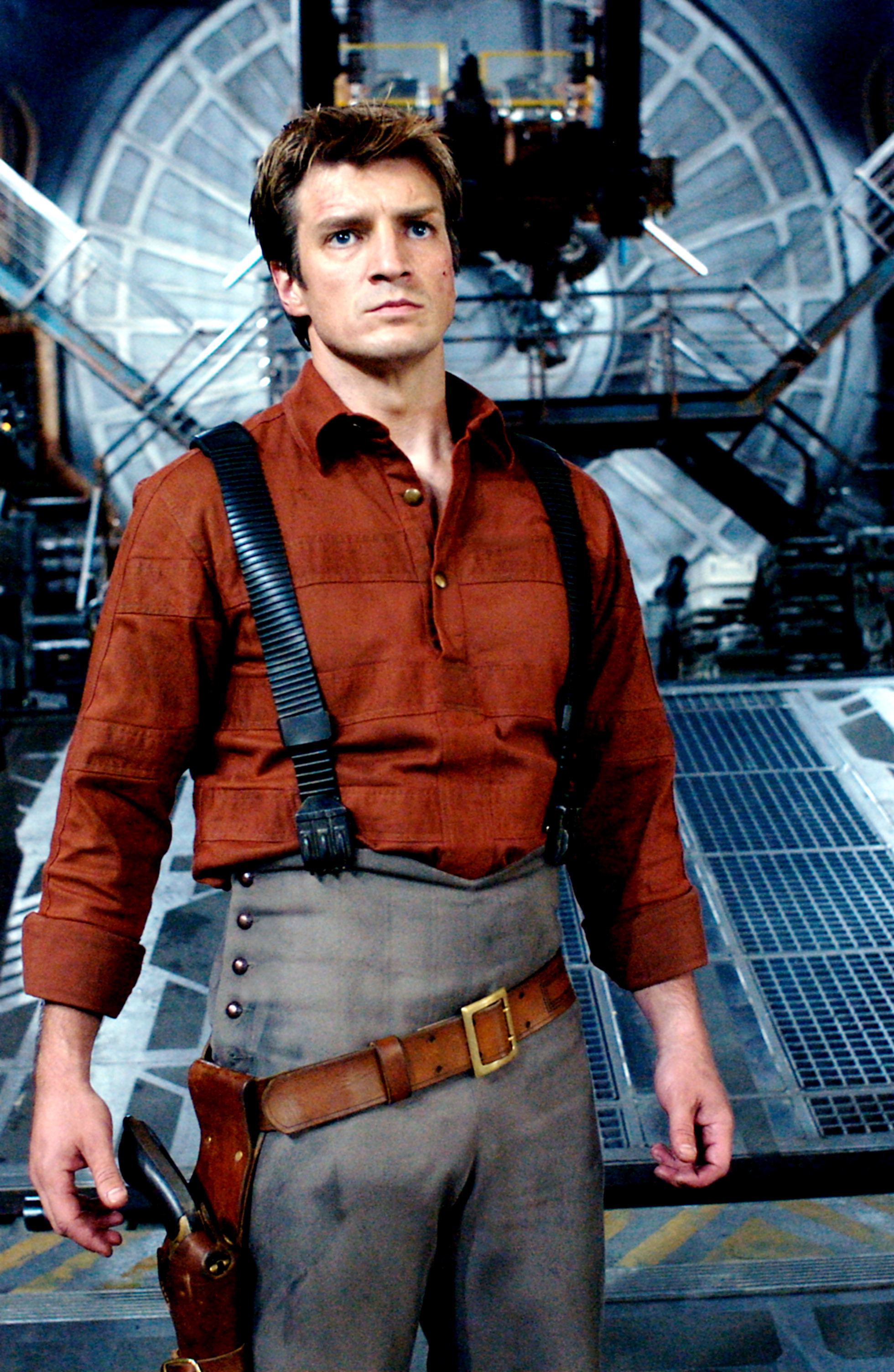 Nathan in pants with suspenders and a weapon hanging from a belt