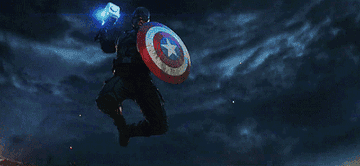 Captain America strikes at a villain using Thor&#x27;s hammer