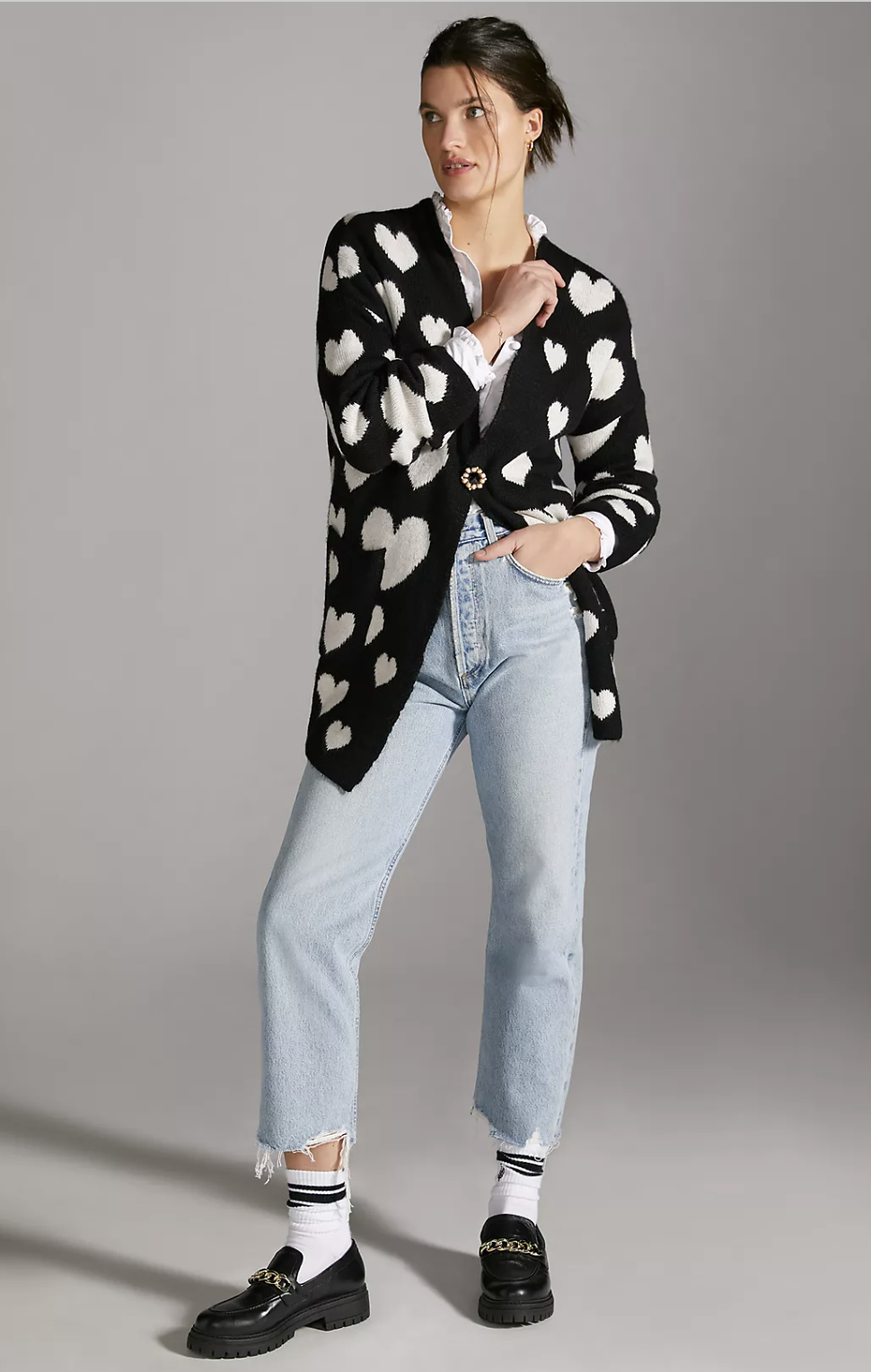 model wearing black and white heart patterned cardigan
