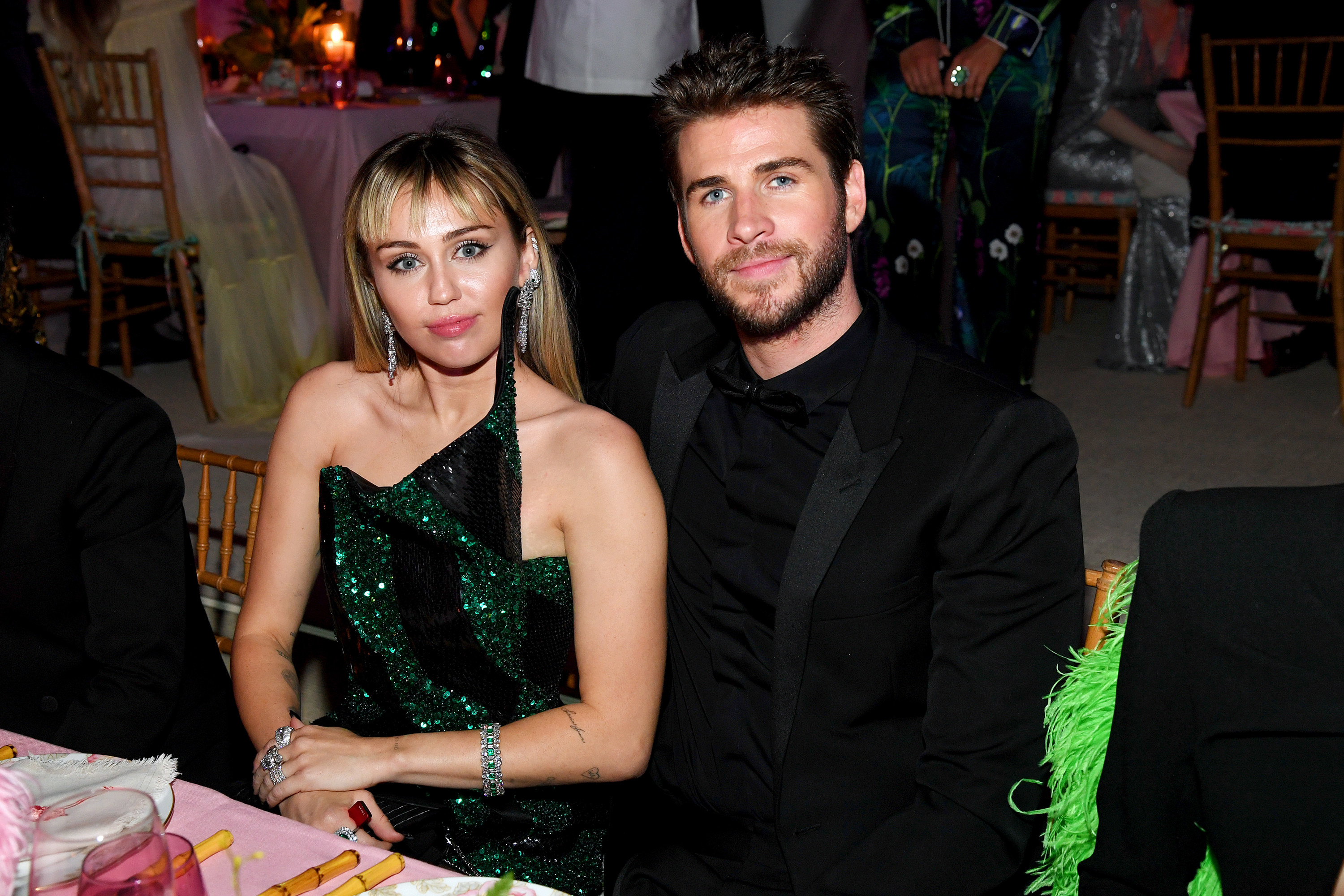 Miley Cyrus and Liam Hemsworth sit at their table during the 2019 Met Gala