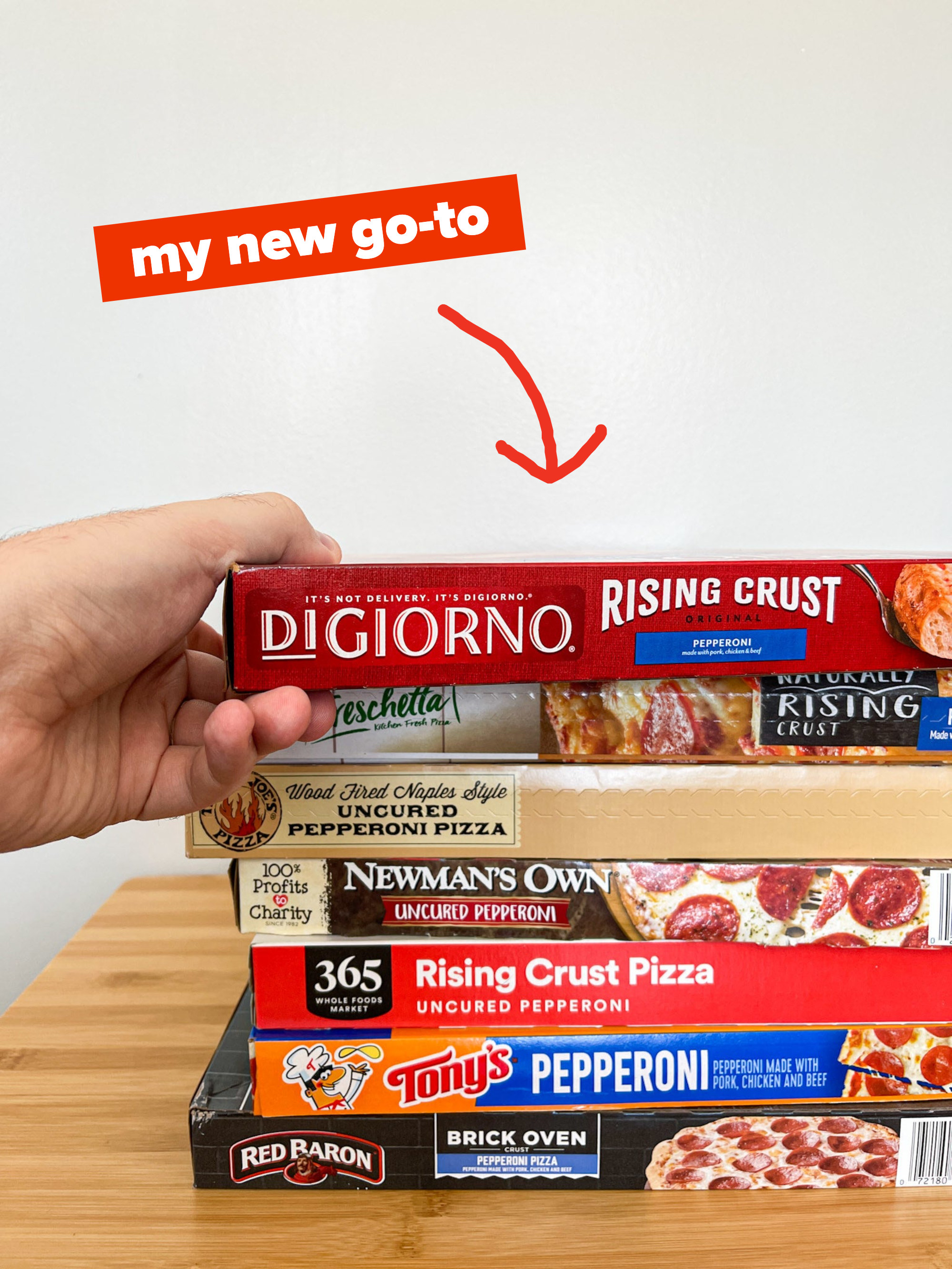 grabb digiorno pizza box off the top of all the stacked pizza boxes
