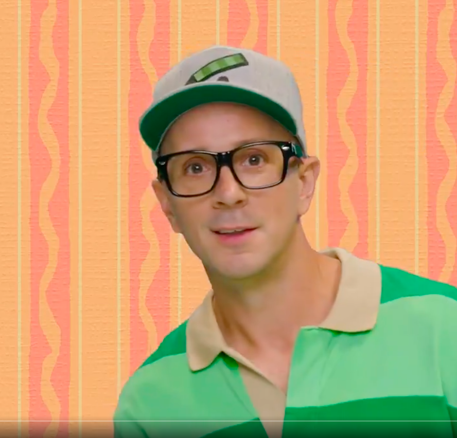 Steve in a cap and glasses and a green striped shirt
