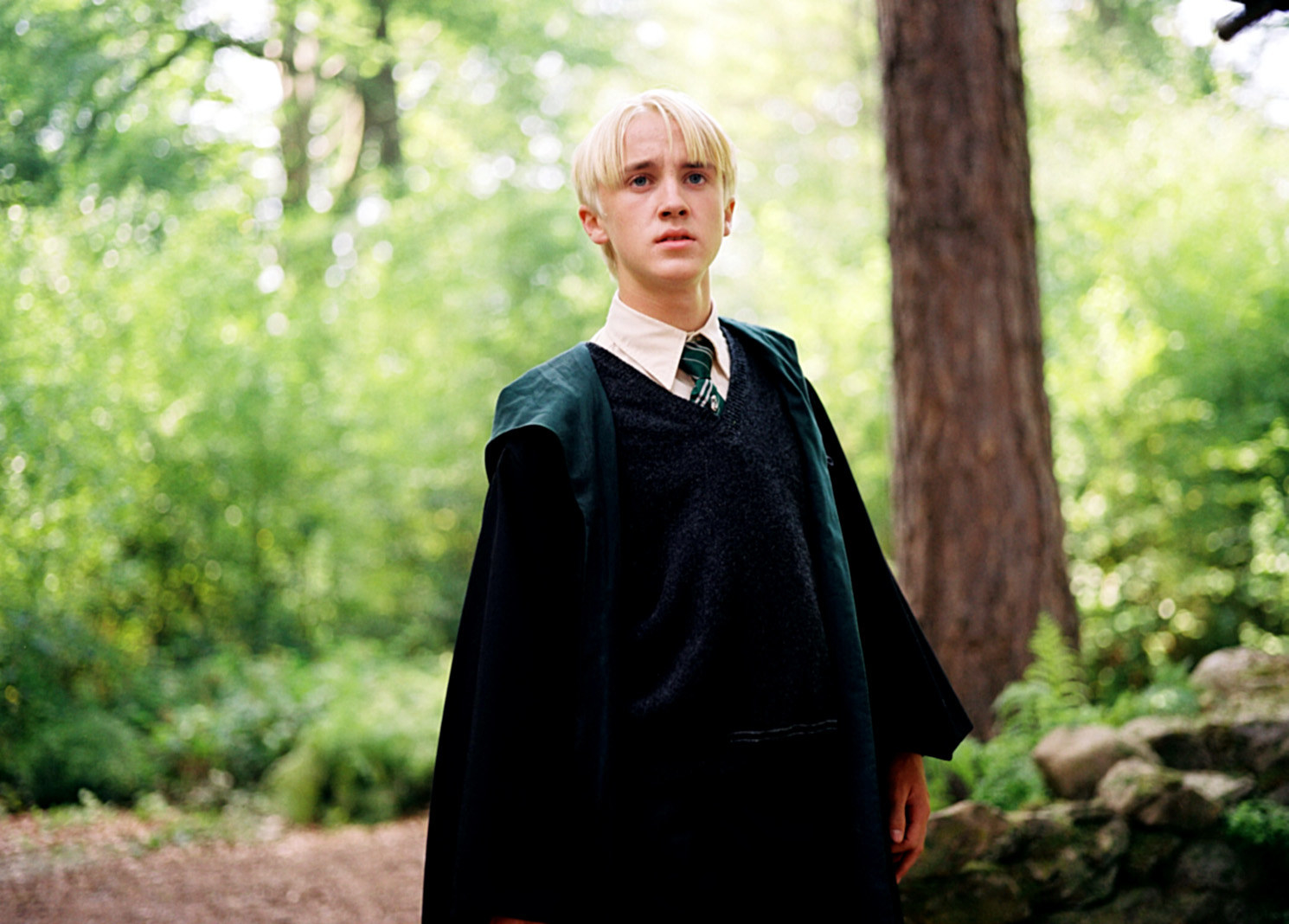 Draco sits down resting his elbows on his knees
