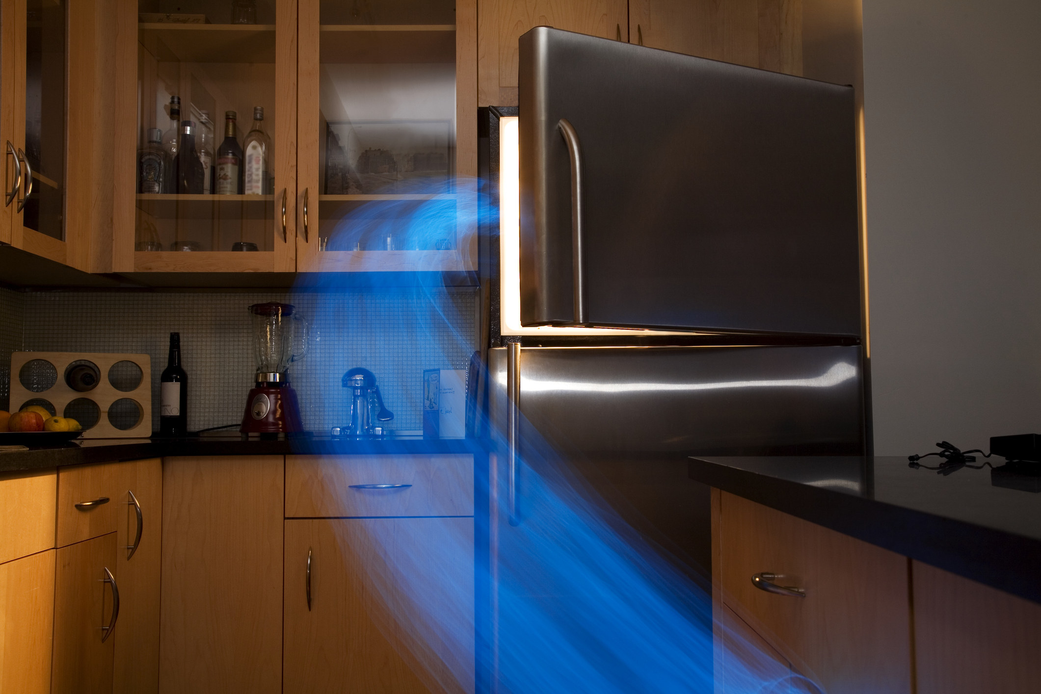 a blue beam coming from an open freezer door