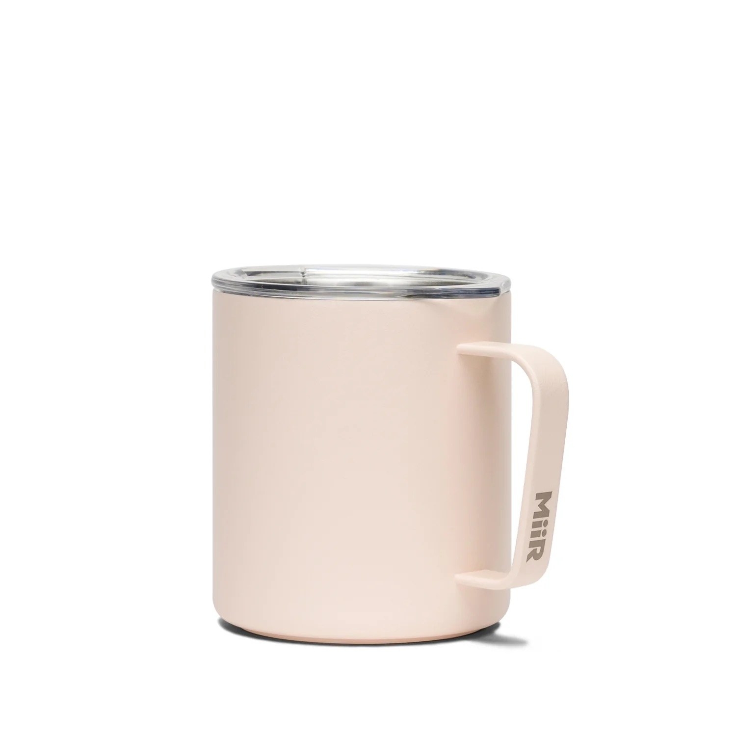 A light pink short mug with a handle and a clear lid