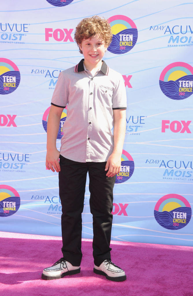 On the Teen Choice Awards red carpet, in shirt and pants