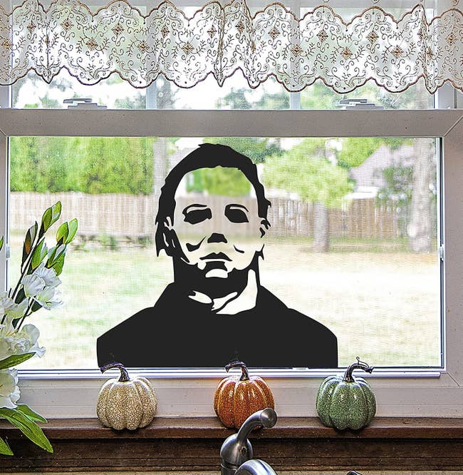 A silhouette of Michael Myers is shown on a window