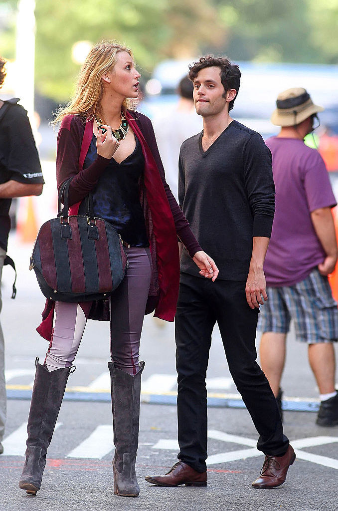 Blake in high boots and tight pants with Penn Badgley in scene from Gossip Girl