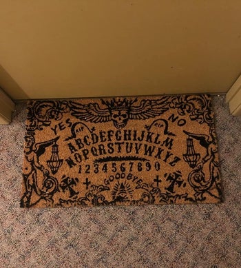 Reviewer's mat is shown on the floor outside their apartment door