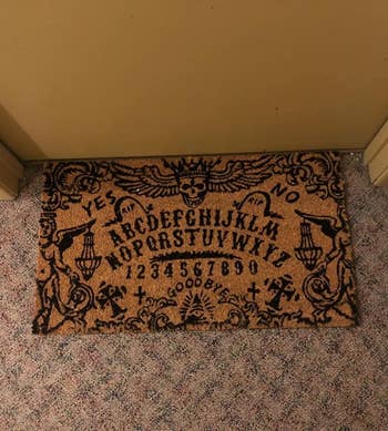 Reviewer's mat is shown on the floor outside their apartment door