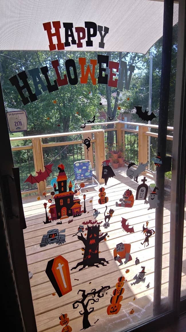 reviewer's photo of the halloween window clings on their large windows