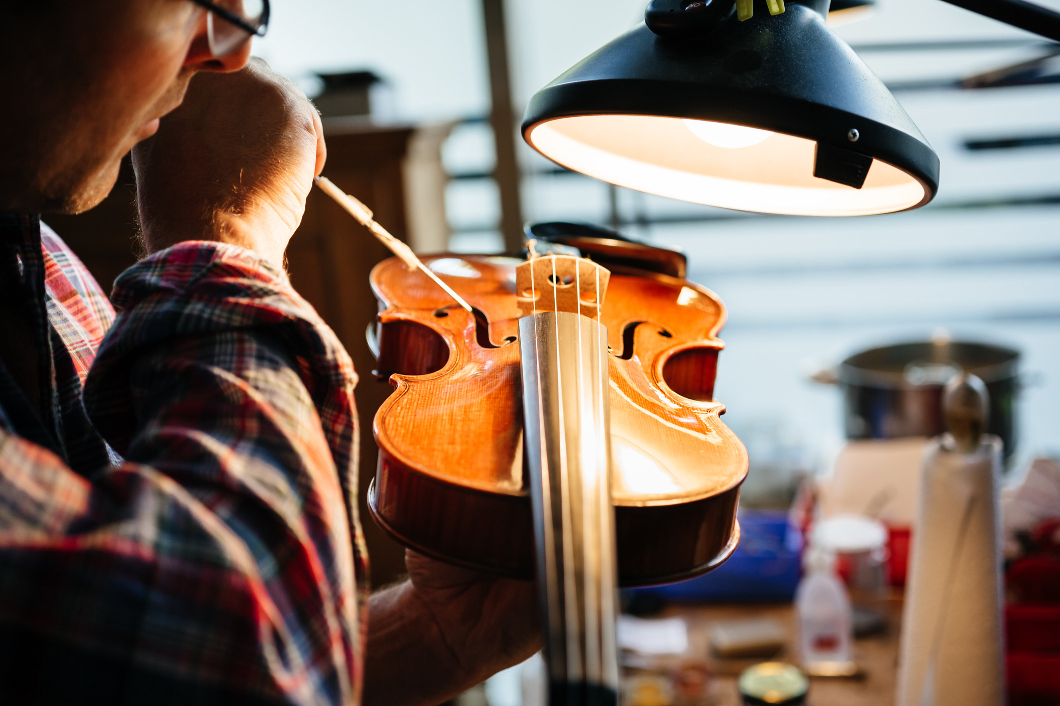 a luthier working on a violin