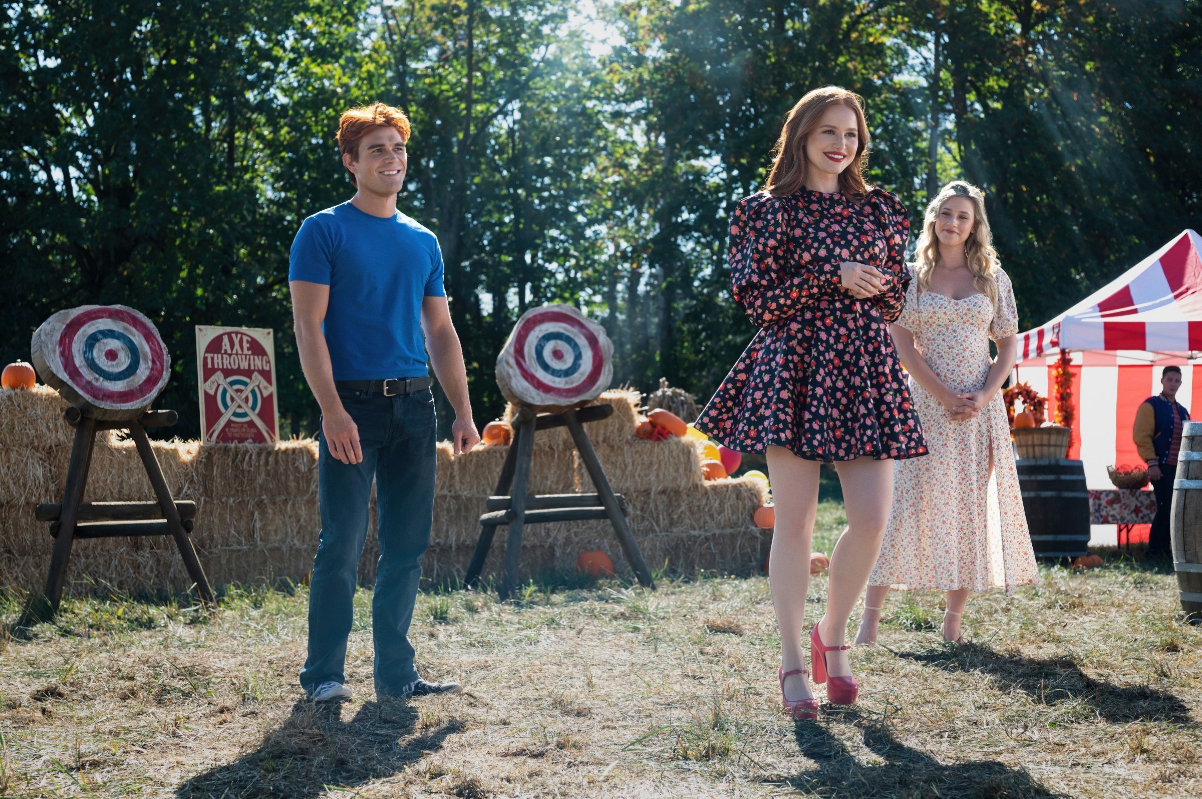 two young women and a young man at a carnival