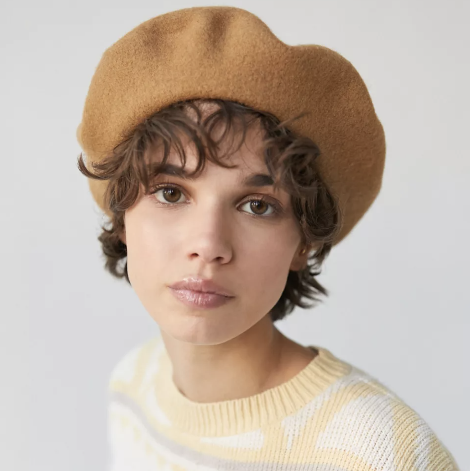 A person wearing the beret with a sweater
