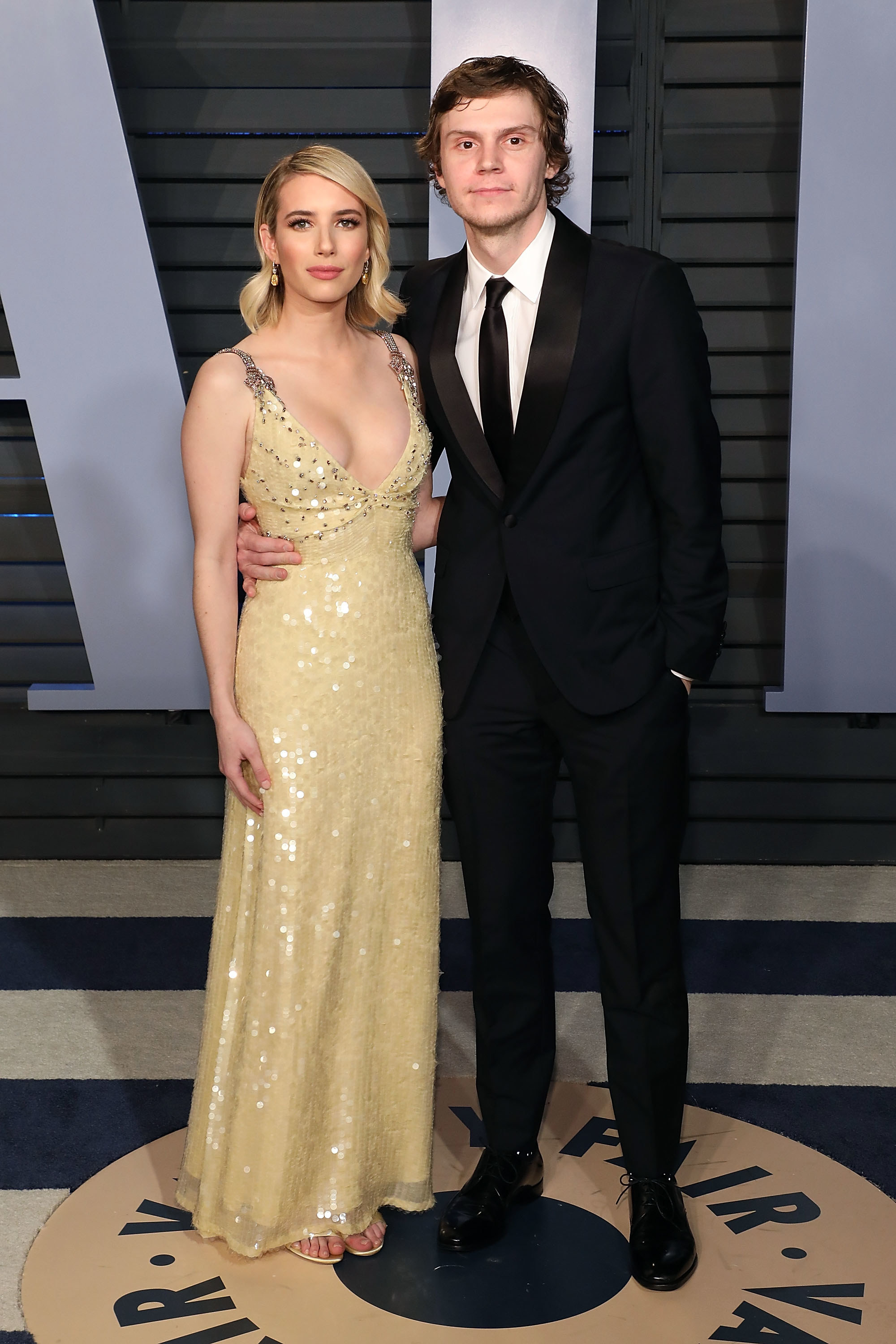 Emma Roberts and Evan Peters pose at the 2018 Vanity Fair Oscar Party