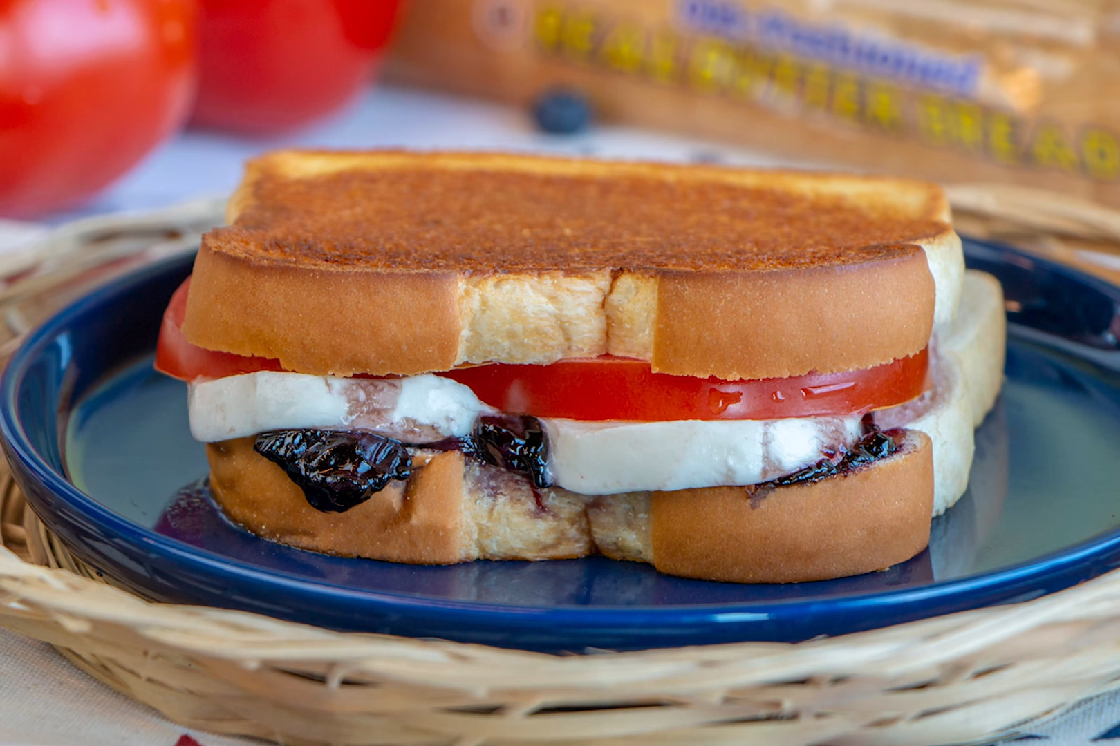 A grilled sandwich with mozzarella and tomato