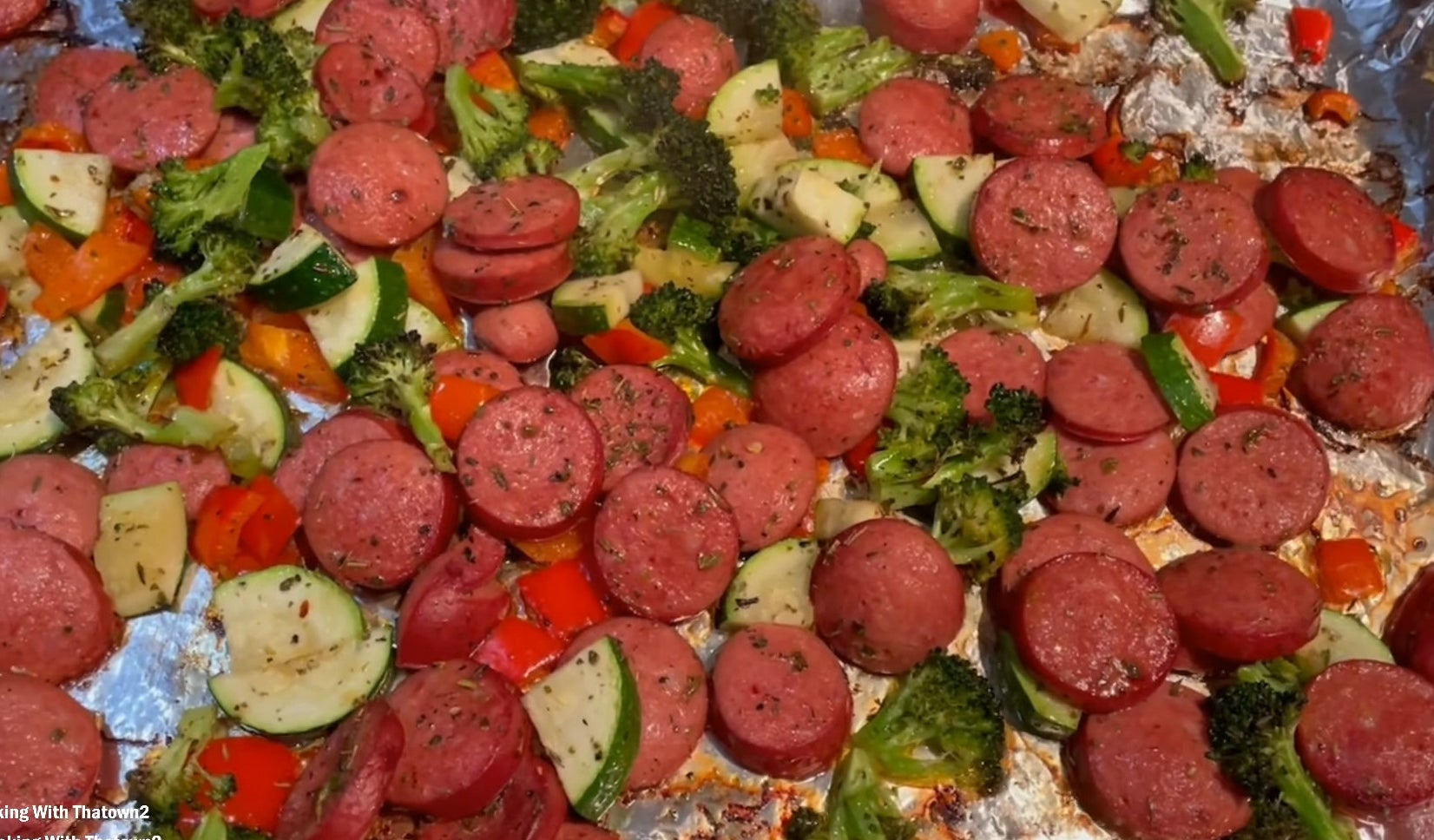 sausage cons and veggies on a sheet pan