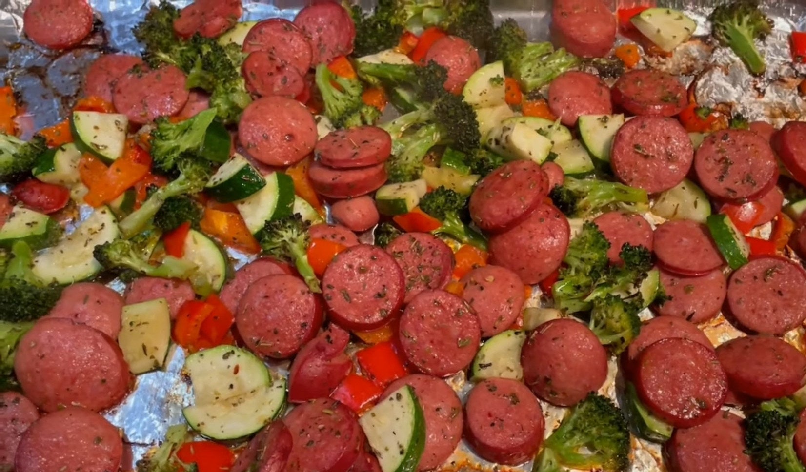 sausage cons and veggies on a sheet pan