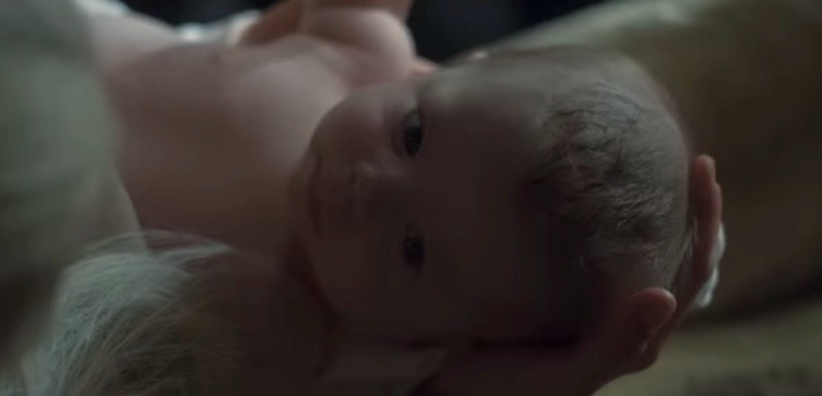 Rhaenyra holds a dark-haired baby