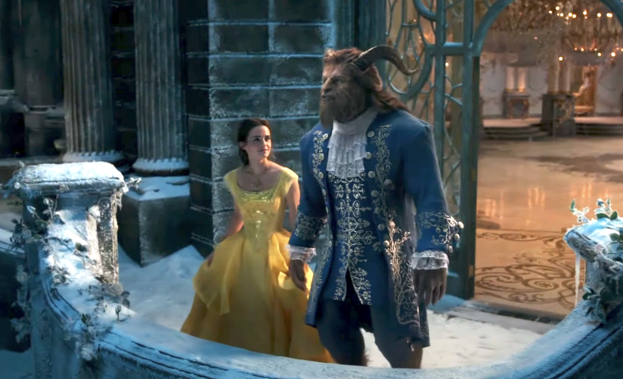 Belle and Beast standing outside on a balcony together