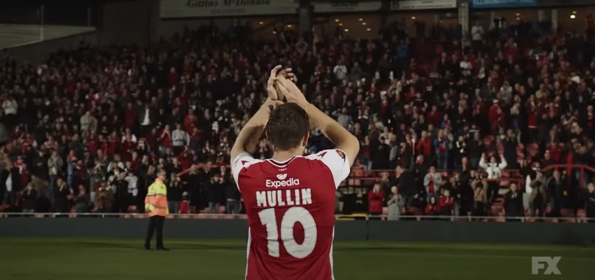 Wrexham player Paul Mullin clapping as the Wrexham fans in the stadium cheer for him