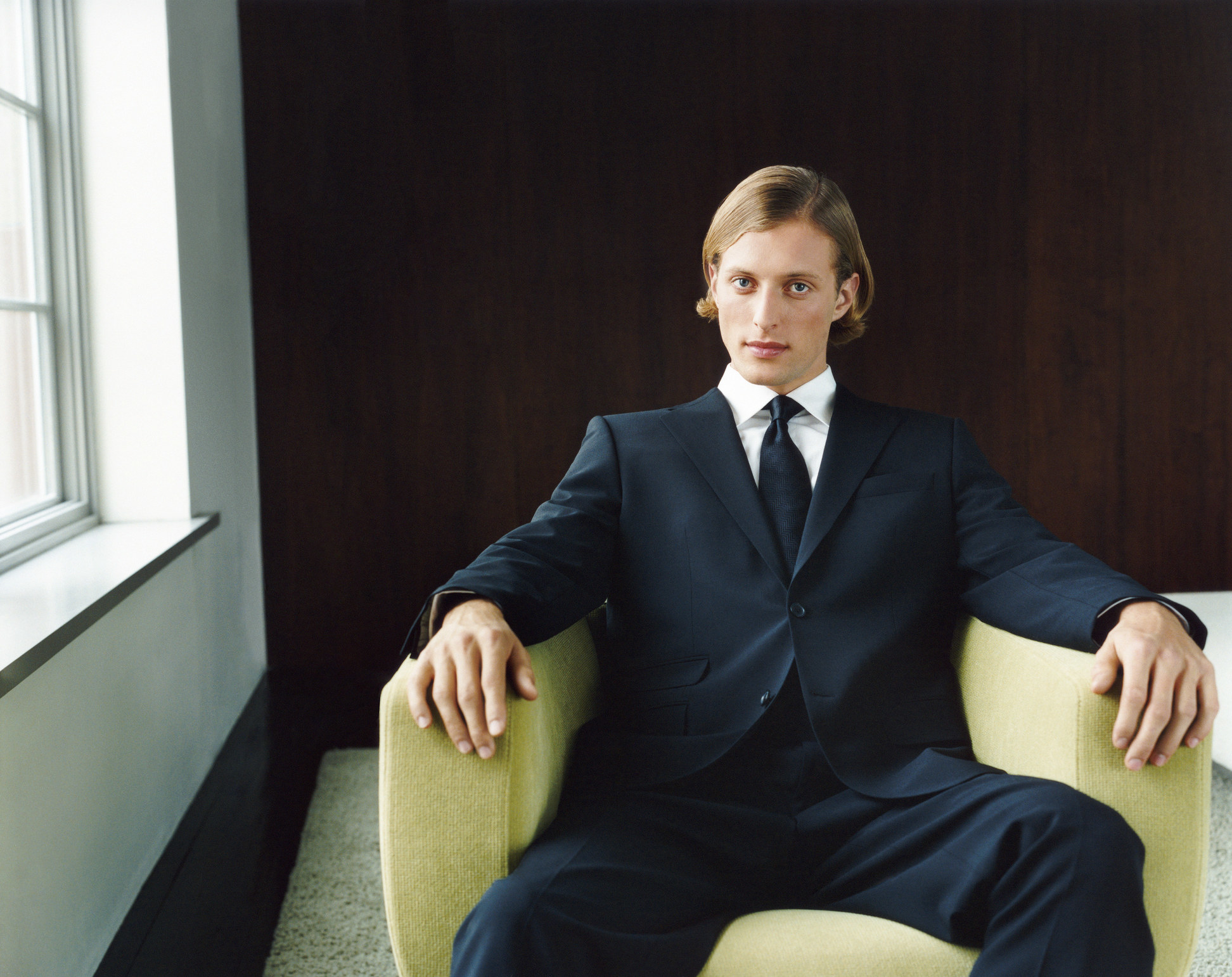 well-dressed man sitting on a chair
