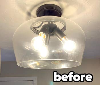 Reviewer photo of dirty glass light fixture before using microfiber cloths