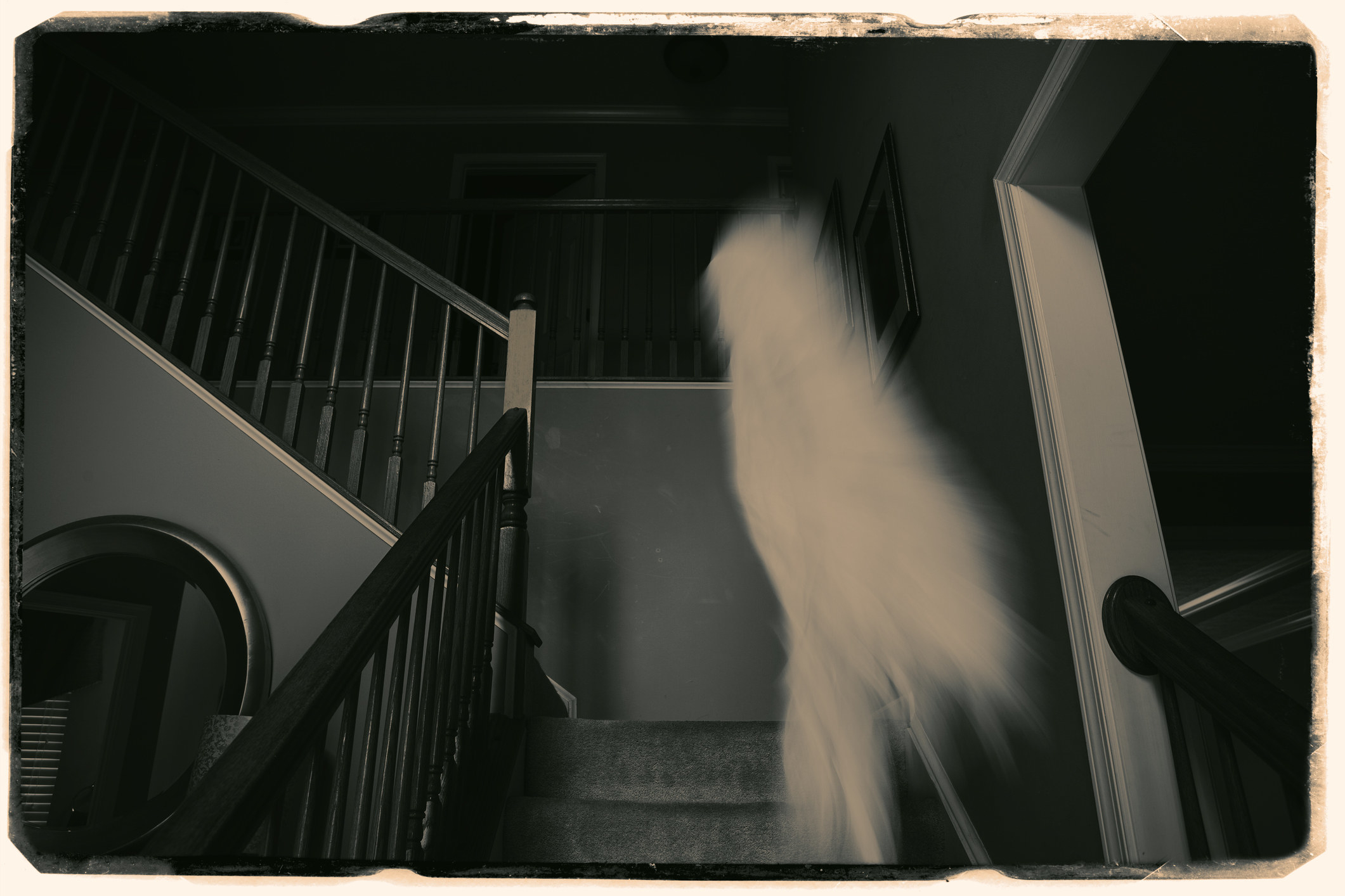 old photo of a ghost-like figure on stairs