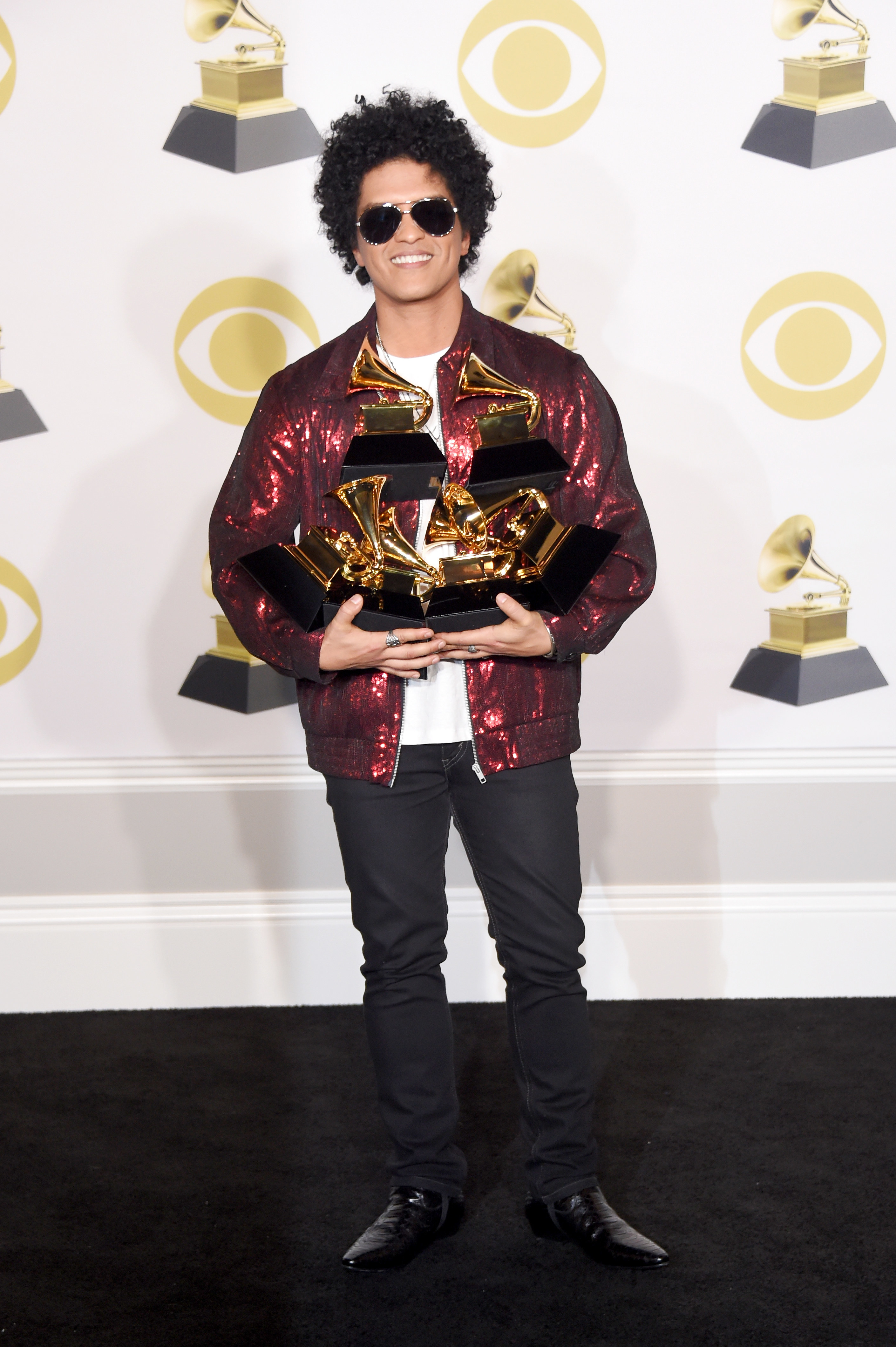 Bruno Mars holds his Grammys and smiles at the Grammy Awards on January 28, 2018