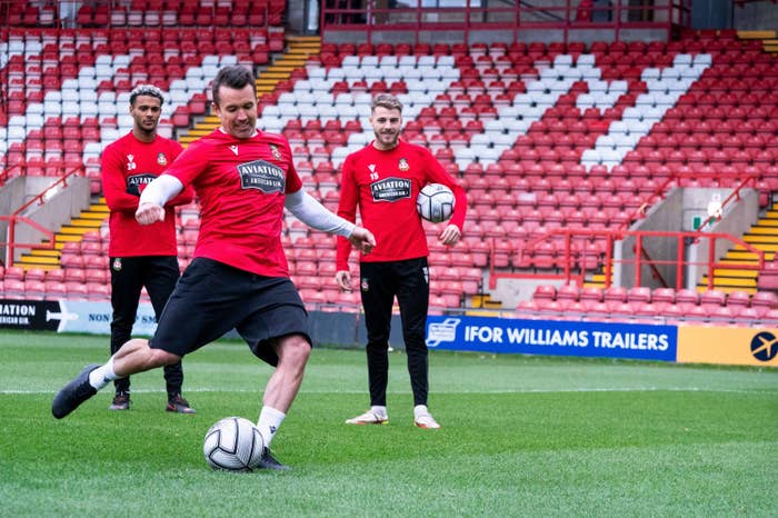 Dior Angus, Rob McElhenney, and Tyler French on the Wrexham field