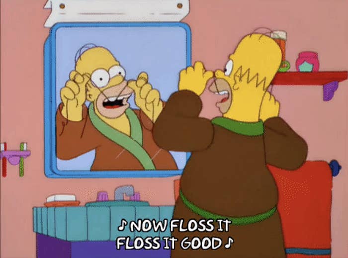 homer flossing in front of the mirror