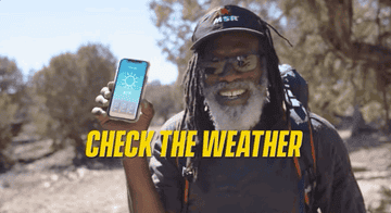 Man pointing at his phone which shows the Colorado weather. Copy reads &quot;Check The Weather&quot;