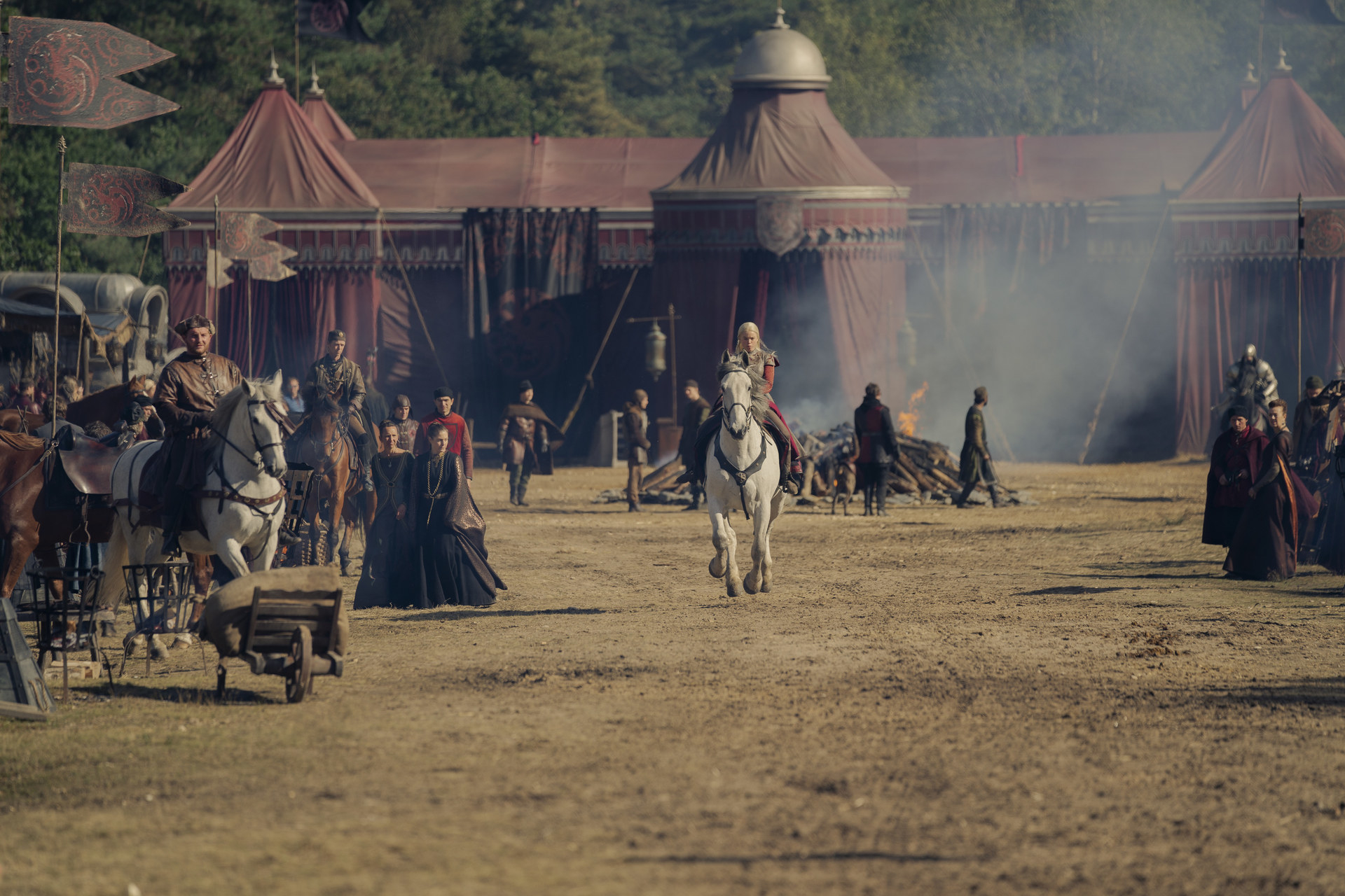 Rhaenyra rides her horse through the royal camp