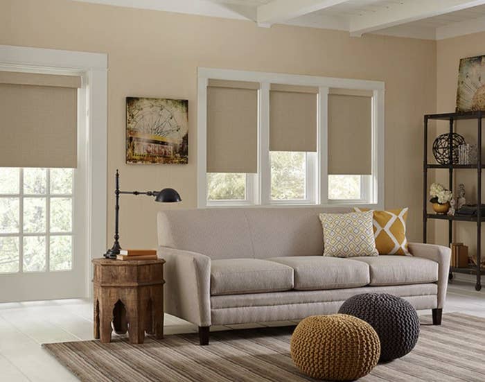 A well appointed living room is shown with blackout shades covering the windows