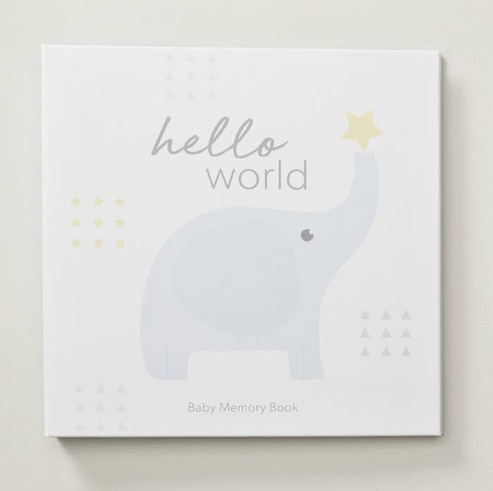the cover of a baby memory book with a tiny elephant illustrated on it