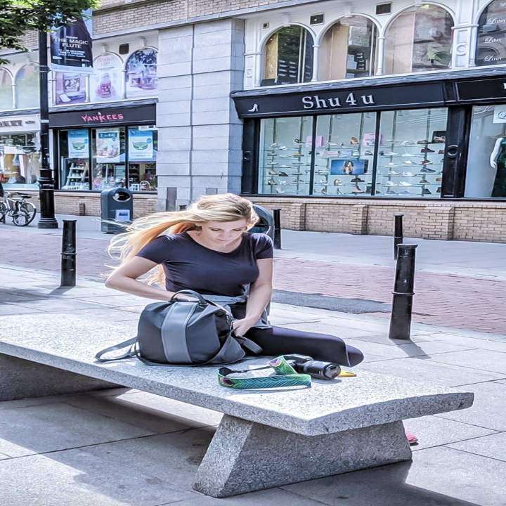 reviewer using backpack on a bench