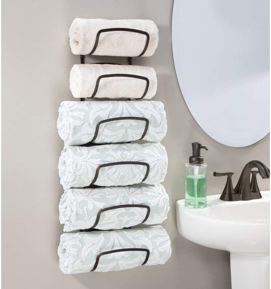 Black metal six-tier towel rack that is mounted on a bathroom wall