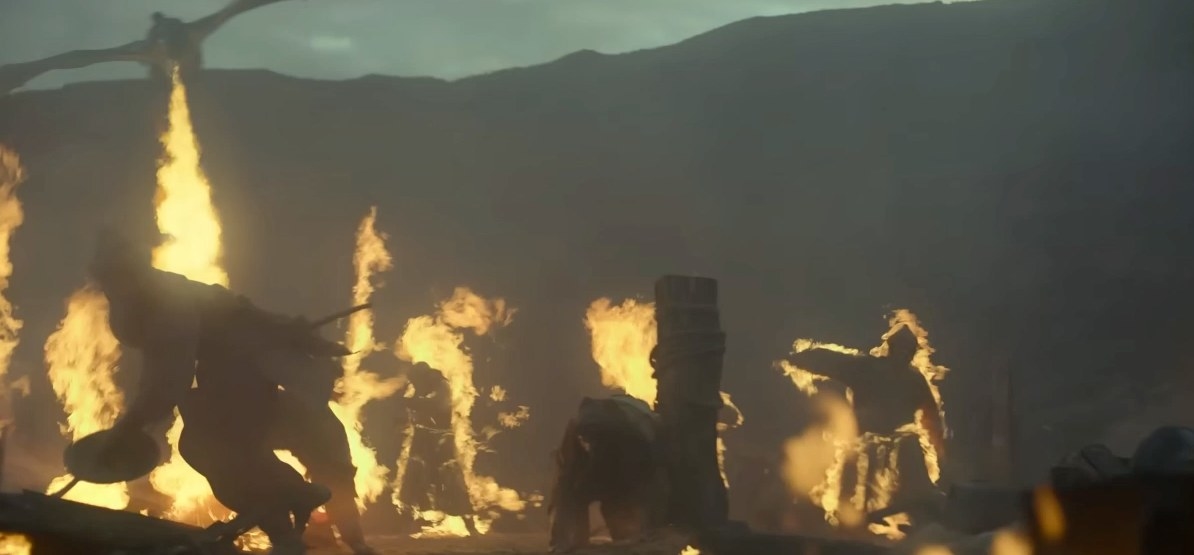 A dragon breathes fire at soldiers