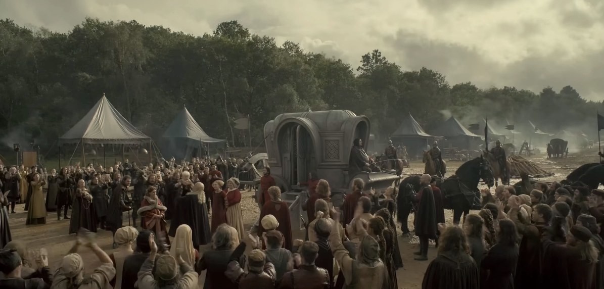 A crowd scene showing the royal party in a clearing inW the woods