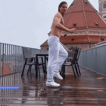 a guy dancing in the rain and spraying on cologne