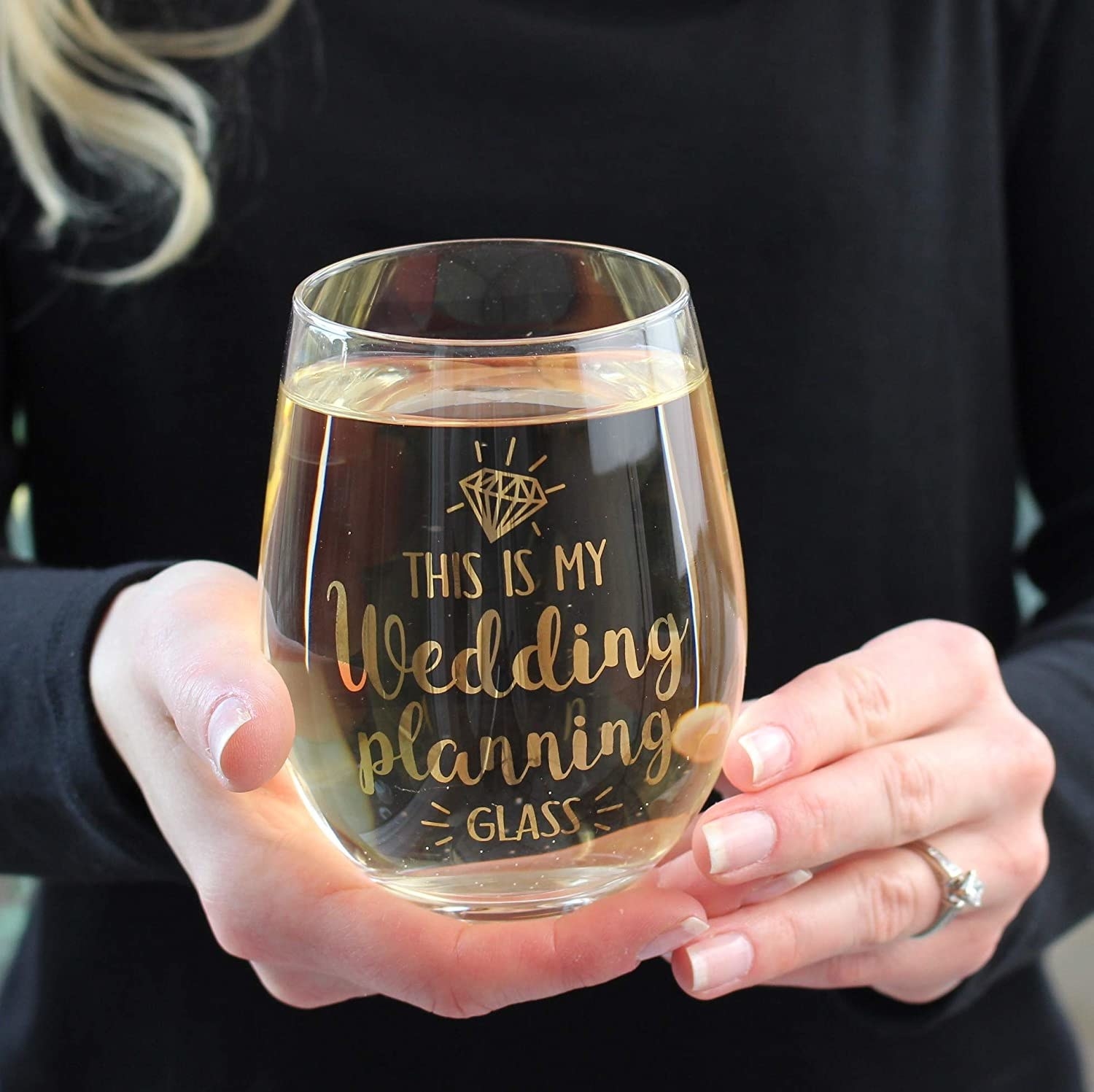 person holding the glass that says this is my wedding planning glass