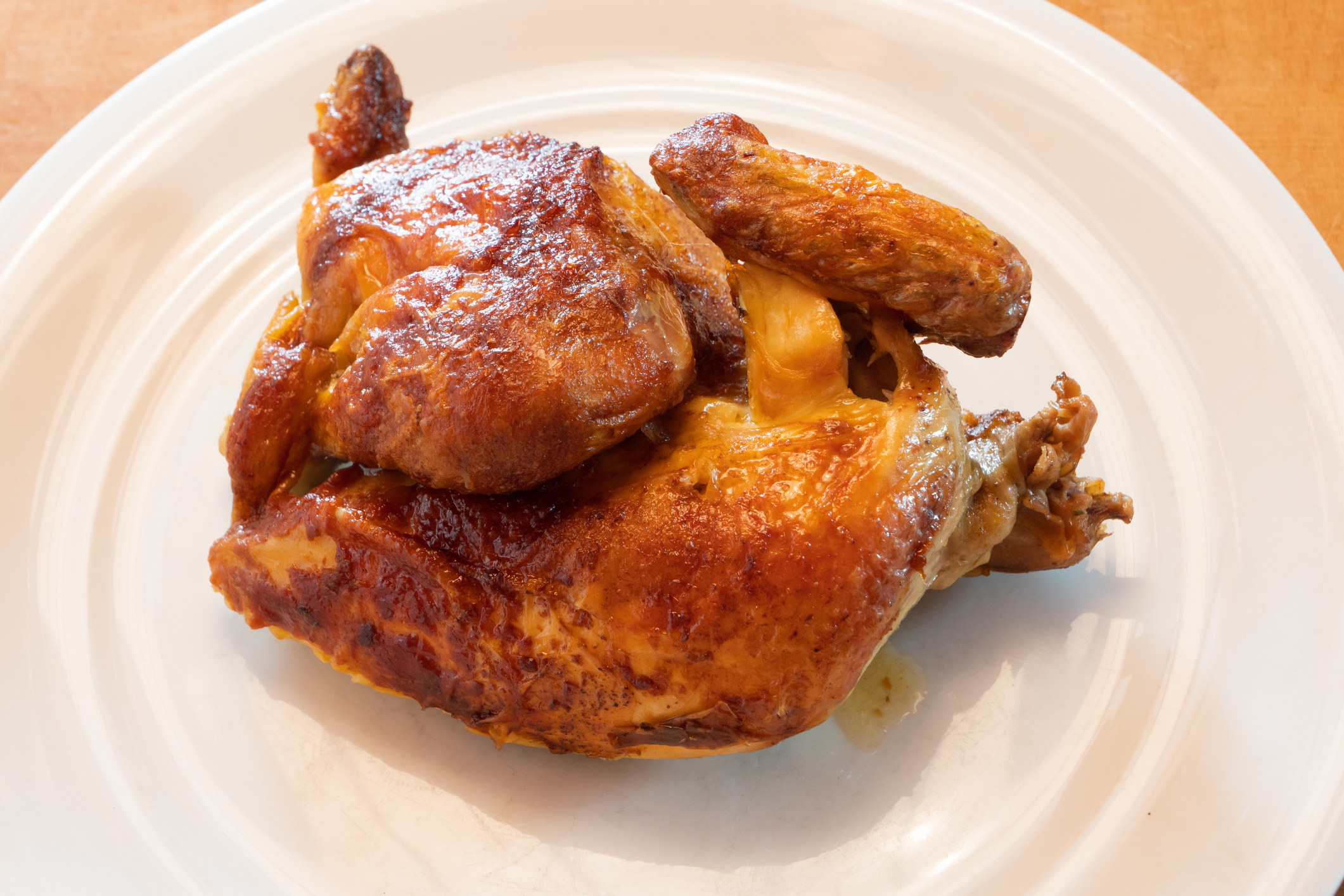 A rotisserie chicken on a plate.